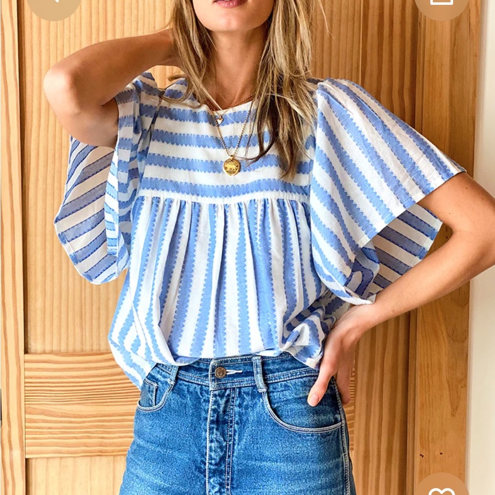 Light blue and white striped top. Billowy top.